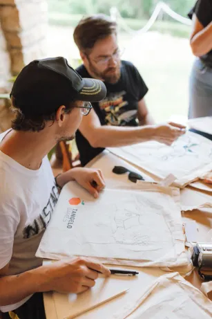 Tangelo Games colleagues drawing together at a creative workshop