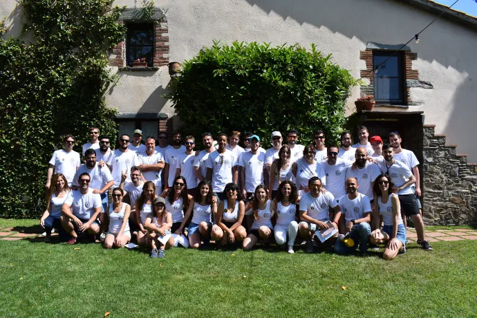 Tangelo Games employees posing for a group photo in matching white shirts