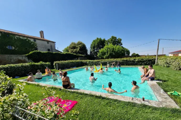 Tangelo Games employees cooling off in the pool at a summer offsite